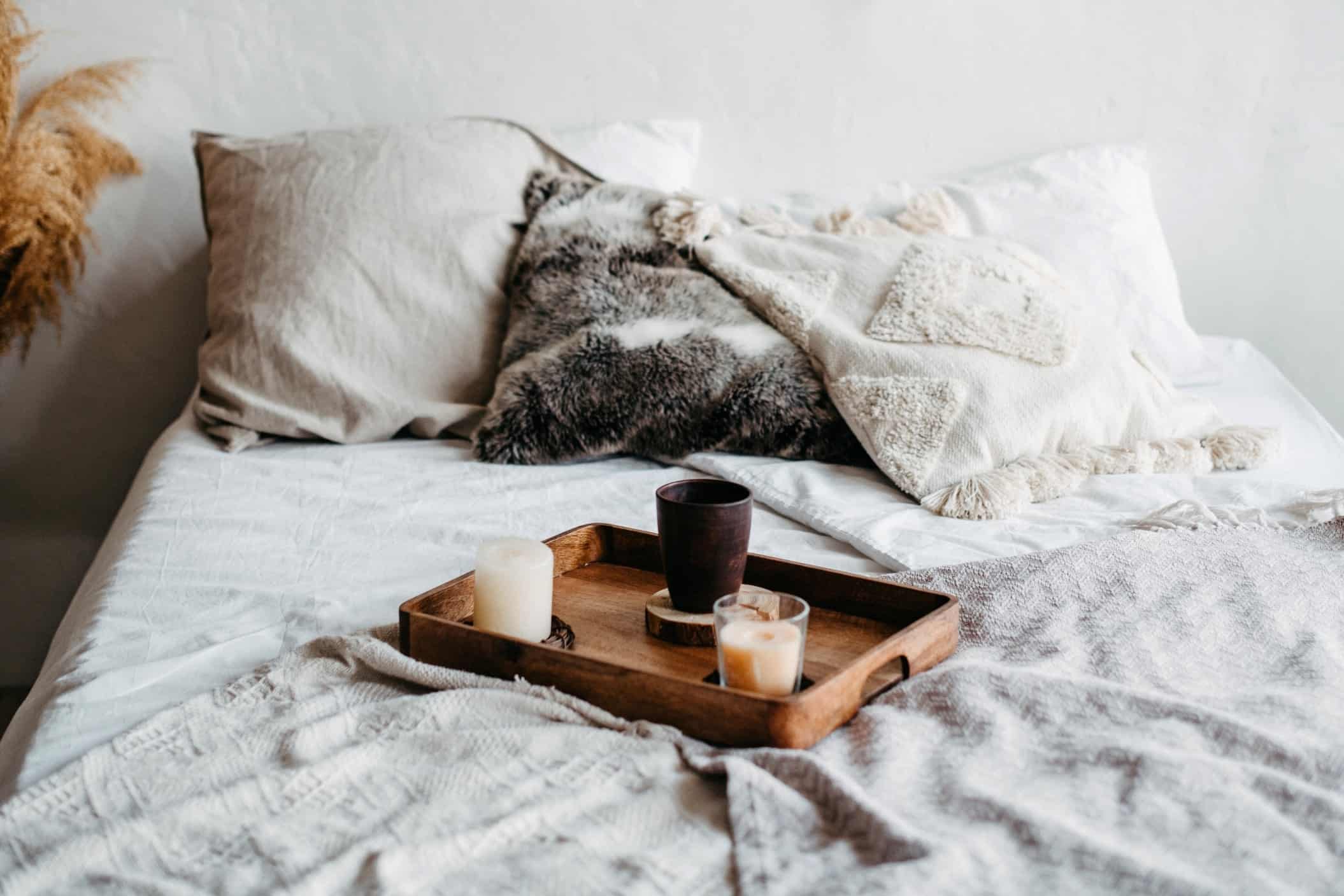 archway wooden tray with candles and a mug on the bed scandinavian interior the apartment is in neutral t20 xgx46b min